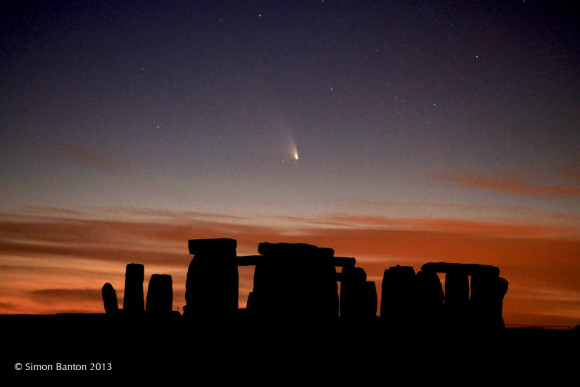 Comet PANSTARRS above the Stonehenge monument in March, 2013.  Image via Simon Banton