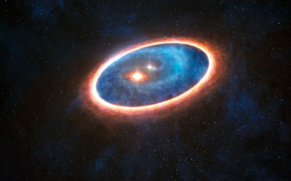 View larger. |  This artist’s impression shows the dust and gas around the double star system GG Tauri-A. Researchers using ALMA have detected gas in the region between two discs in this binary system. This may allow planets to form in the gravitationally perturbed environment of the binary. Half of Sun-like stars are born in binary systems, meaning that these findings will have major consequences for the hunt for exoplanets.  Image via ESO/L. Calçada