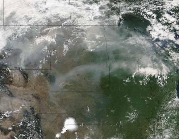 On August 21, 2015 the Aqua satellite captured this image of the smoke from the fires on the west coast of the United States wafting eastward on the jet stream.  In this image the smoke is obscuring parts of Montana, North and South Dakota, Minnesota, and Wisconsin.  Residents of these states are on notice that sunsets will be much redder and more orange as long as the smoke lingers over their area. The reason? The size of the smoke particles is just right for filtering out other colors meaning that red, pink and orange colors can be seen more vividly in the sky. Image credit: Jeff Schmaltz, MODIS Rapid Response Team.