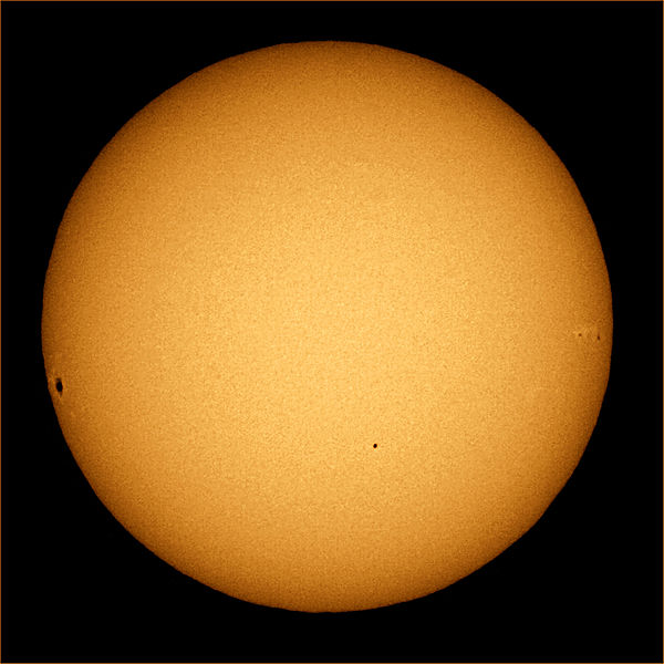 When Mercury swung in front of the sun on November 8, 2006, it appeared as a small black dot (lower right of center), not nearly as conspicuous as the big sunspot at the left edge of the solar disk. Photo by Brocken Inaglory. 