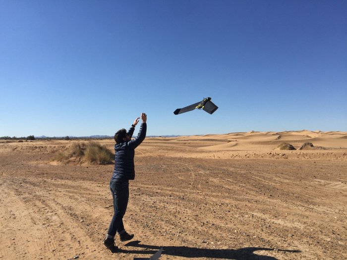 Man releasing flying drone