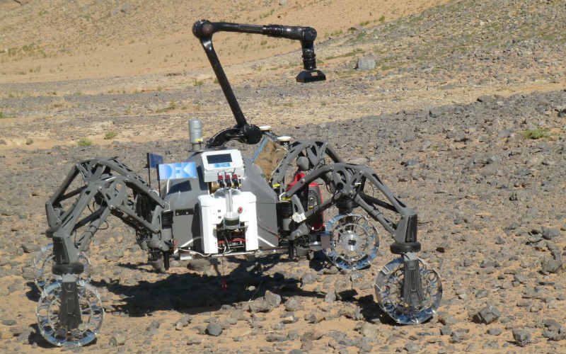 Four-wheeled Mars rover with arm on top