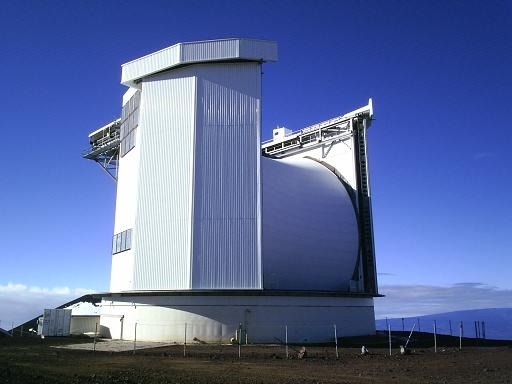 Giant telescope with huge horizantal cylinder between two buildings. 
