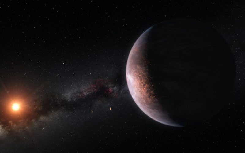 Rocky-looking planet seen from orbit with distant sun and Milky Way in background.