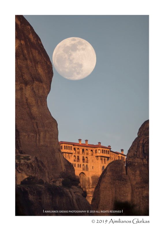 Full moon on a monastery, view between 2 rocks