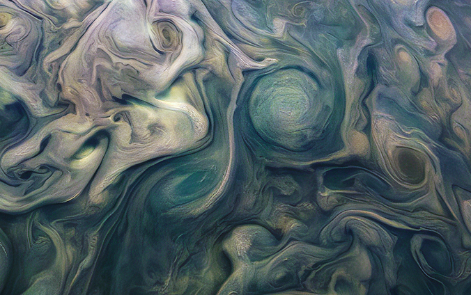 Blue whirlpools detailed in the atmosphere of the planet Jupiter.