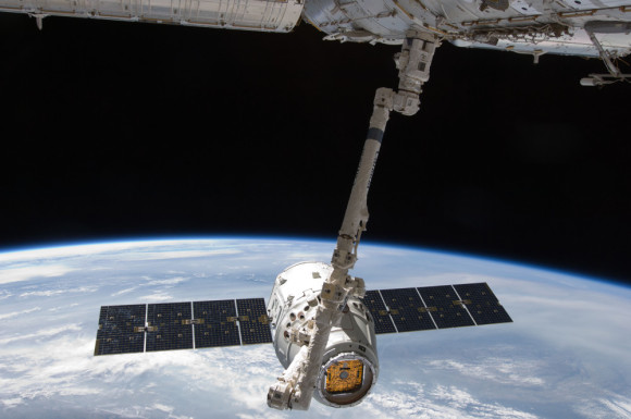 The first SpaceX Dragon capsule pauses near the International Space Station on May 31, 2012 so the ISS' robotic arm can grapple and berth it to a port on the station. Today's Dragon departure from ISS was similar. Photo via NASA