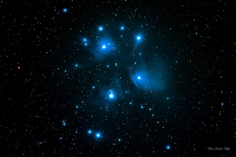 Several bright white stars in glowing blue patches against a starry background.