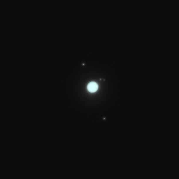 A dim blue ball (Uranus), with 4 much-fainter dots near it.