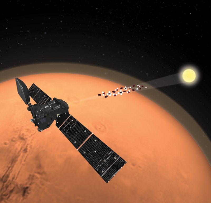 Spacecraft with wide solar collectors orbiting Mars.