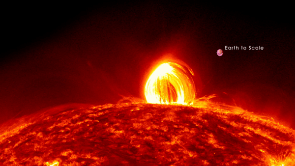 Bright glowing loop-shaped prominence on boiling red-colored sun.