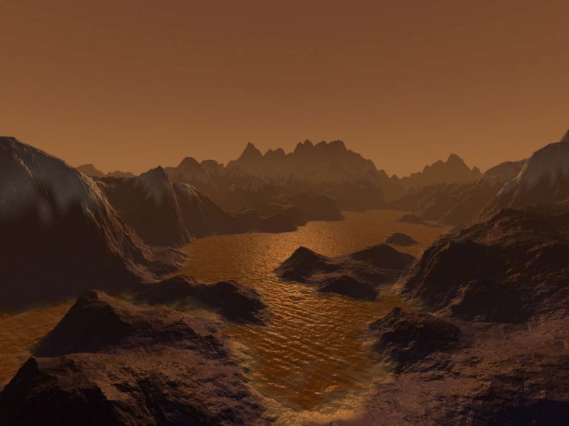 Steep mountains surround reddish lake under dim, pale tan sky.