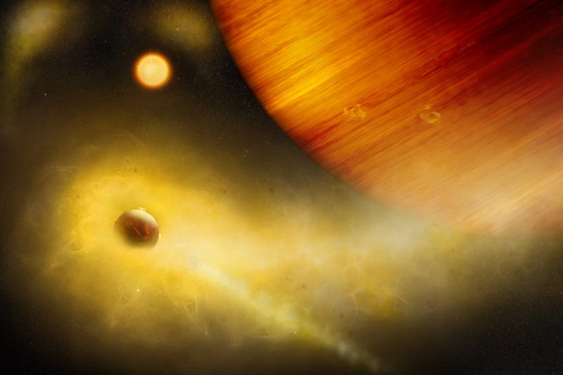Gas giant planet on right with volcanic moon surrounded by large yellow cloud of gas.