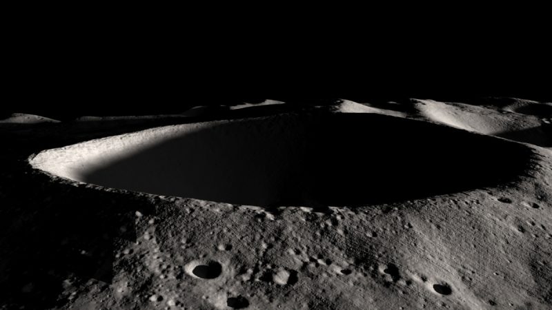 Oblique view of deep crater with shadows on the moon.