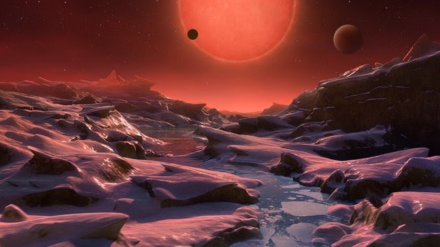 Rocky landscape, stream of water, looming red sun, two other planets visible in the dark red sky.