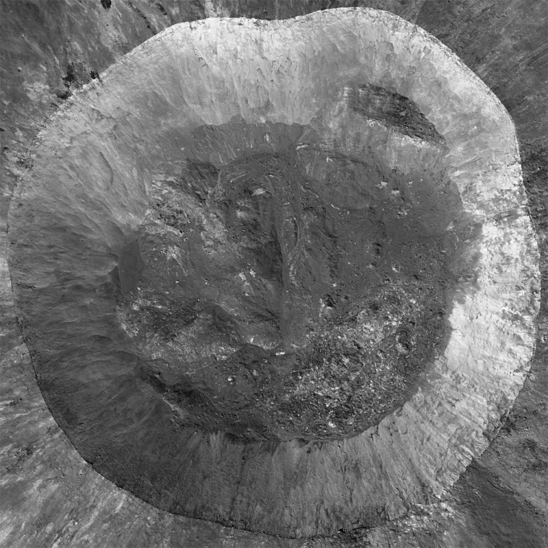 Large crater seen from directly overhead. Wide gray circle with rough darker gray center.