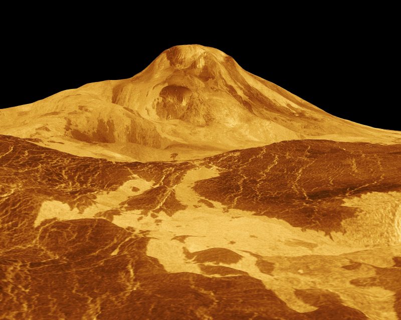 Tall glowing mountain against black background, lake-like yellow features at its base.